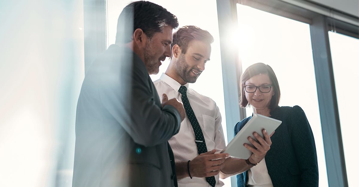 Group of businesspeople using a digital tablet together